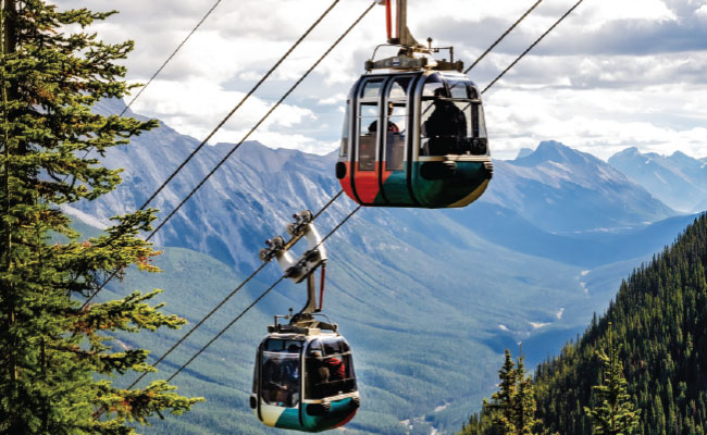 » Country Heritage Tours Two gondolas passing each other with mountains in the background