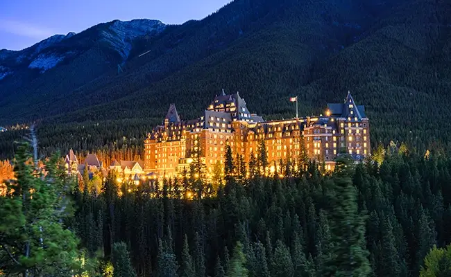 » Country Heritage Tours Beautiful stately hotel lit up at night in the Canadian Rockies