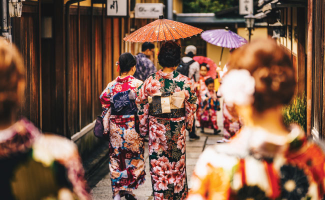» Country Heritage Tours Japanese women wearing traditional clothing walking down the street holding a paper umbrella