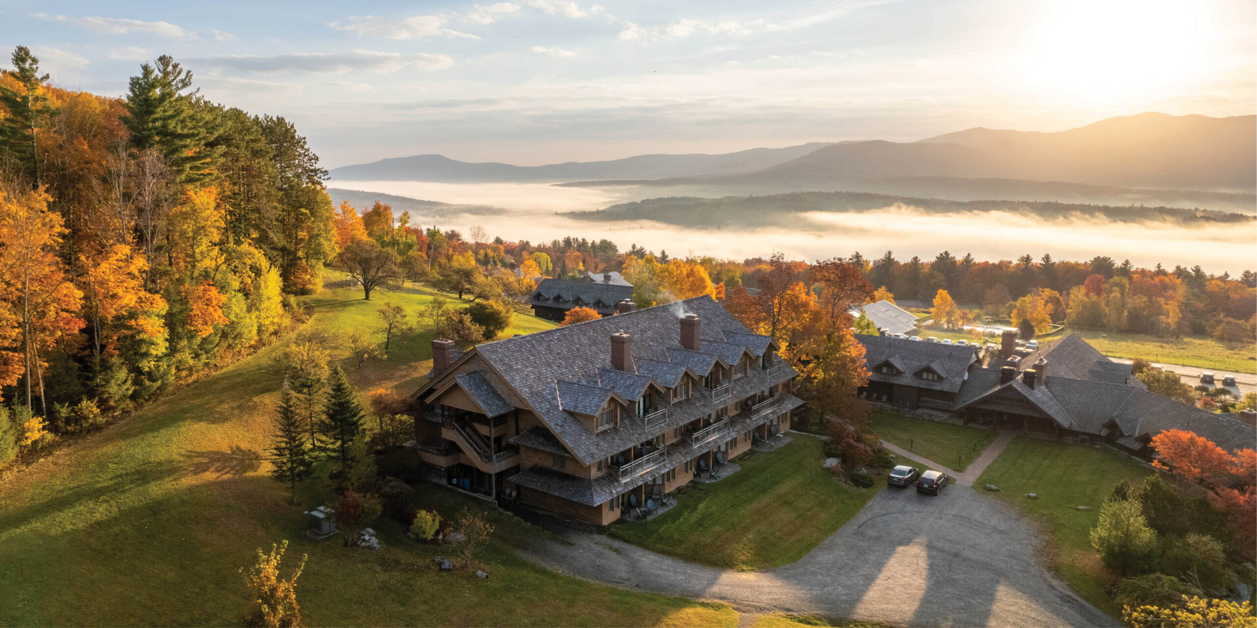 » Country Heritage Tours » Country Heritage Tours view of trapp lodge overlooking green mountains as fog rolls in